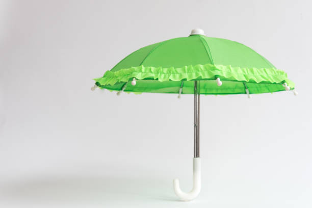 istock Green umbrella on a white background. Protection and safety concept 1354406089