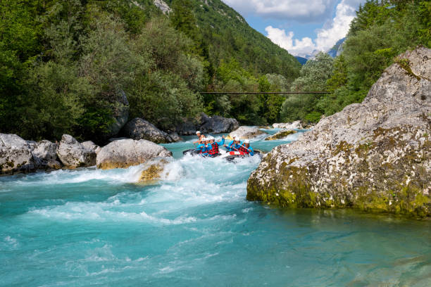 Riding down white water in nice valley, turquoise water flowing among rocks and stones Riding down white water in nice valley. Turquoise water flowing among rocks and stones. Rafting in wild mountain Soca river, Slovenia. primorska white sport nature stock pictures, royalty-free photos & images