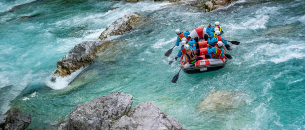 istock People cooperating in adjusting position of raft before entering challenging part 1354408330