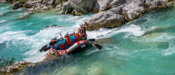 istock Paddlers in raft riding down white water rapids in valley 1354408332