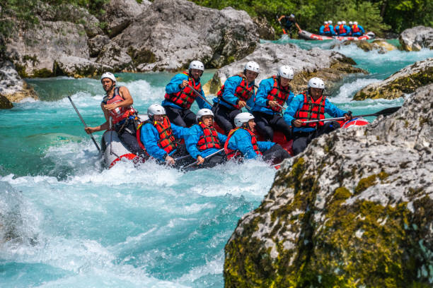 istock Group of people enjoying adrenaline activity in gorge, riding through rapids between rocks 1354408342