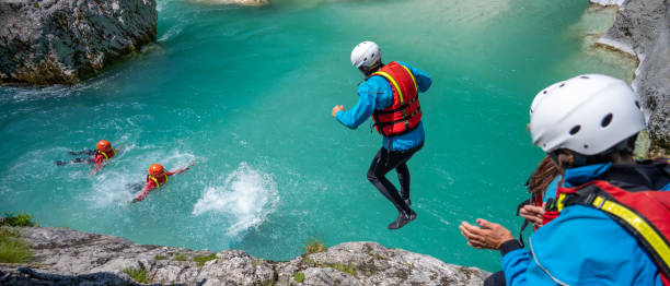 istock People jumping into cold mountains stream in limestone gorge 1354408350