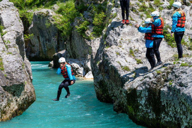 istock Adventurous activity with jumping into mountain river from limestone rock 1354408353