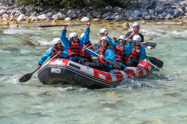 istock Happy smiling people on raft during riding down clear water 1354408361