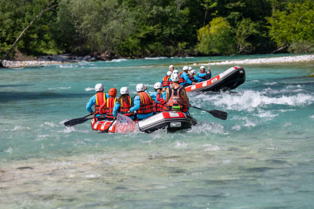 istock Two rafts riding down crystal clear turquoise water in nature 1354408372