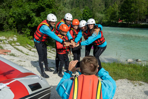 istock Man making photo of raft crew encouraging before adrenaline ride 1354408384