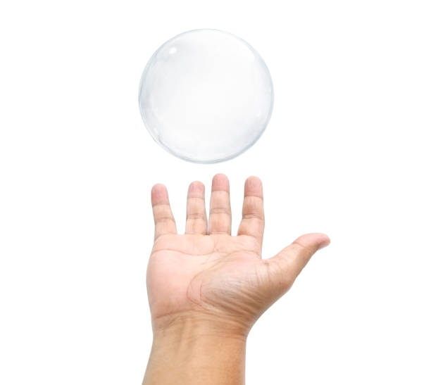 istock Some one trying to catch soap bubbles. Hands trying to catch floating soap bubbles 1354410219