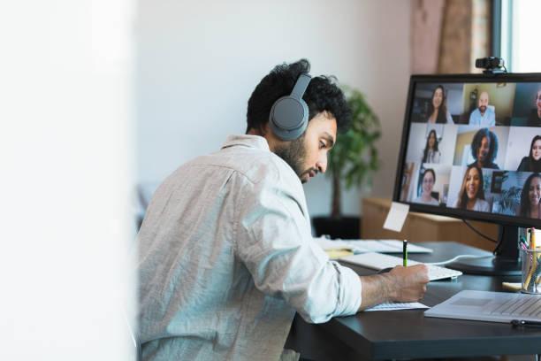 istock Businessman takes notes during meeting 1354411862