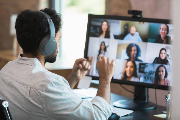 istock Man participates in virtual staff meeting 1354411875