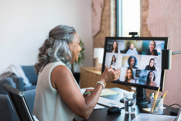 istock Senior businesswoman talks virtually with coworkers 1354411896