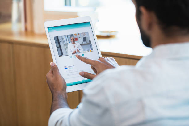 istock Young man participates in telemedicine appointment 1354411911