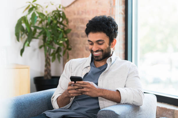 istock Young man uses smartphone 1354411943