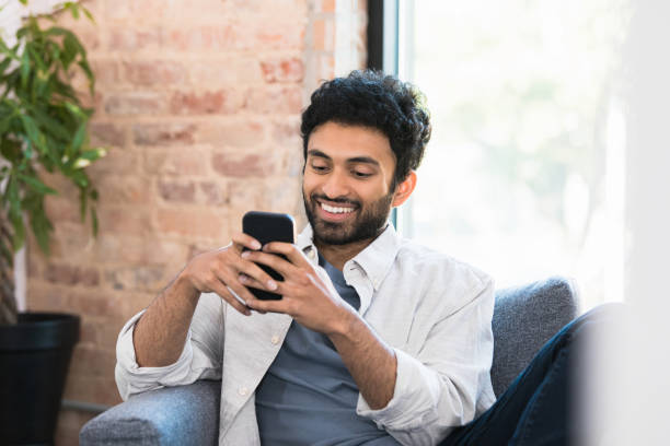 istock Smiling man reads social media post 1354411946