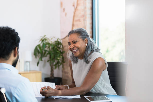 istock Female financial advisor discusses financial plan with client 1354411965