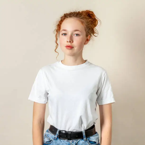 Photo of Studio portrait of 15 year old teenage girl with curly red hair