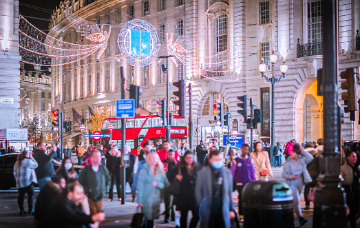 London UK - November 18, 2021: Festive decorations and Christmas lights in London. Piccadilly Circus with lots of people crossing the road