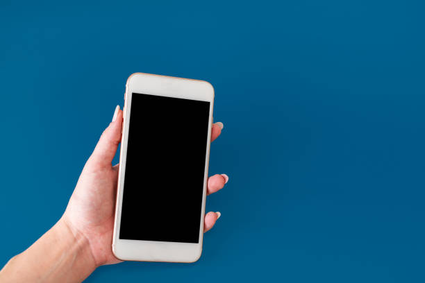istock Woman hand holding phone 1354415222