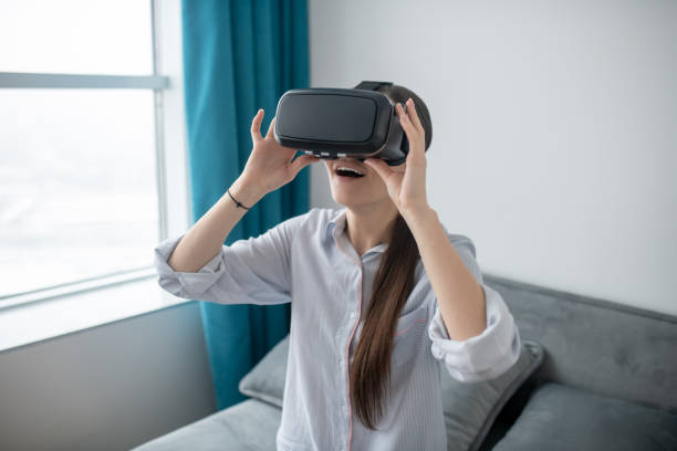 istock Female in VR glasses enjoying virtual reality 1354419389
