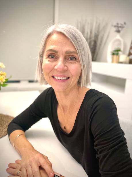 istock Senior woman sitting at dining table 1354419512