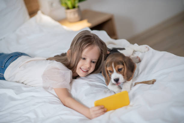 istock Female child taking selfies with her dog 1354419525