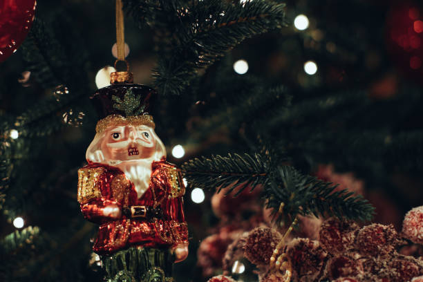 istock Christmas toy soldier Nutcracker figurine hanging on the Christmas tree. 1354419728
