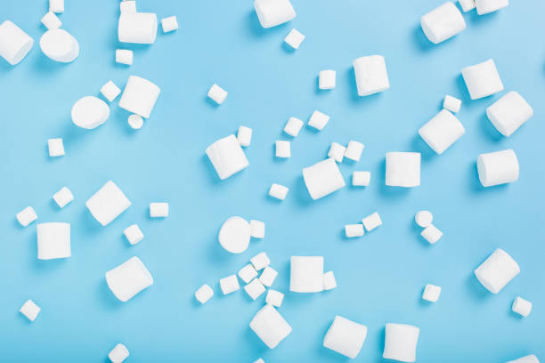 istock White marshmallows on a blue background. Top view, flat lay. 1354420479