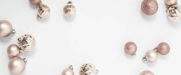 istock Beautiful golden decorative balls on a white background. Top view, flat lay. Banner. 1354421149