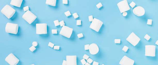 istock White marshmallows on a blue background. Top view, flat lay. Banner. 1354421445