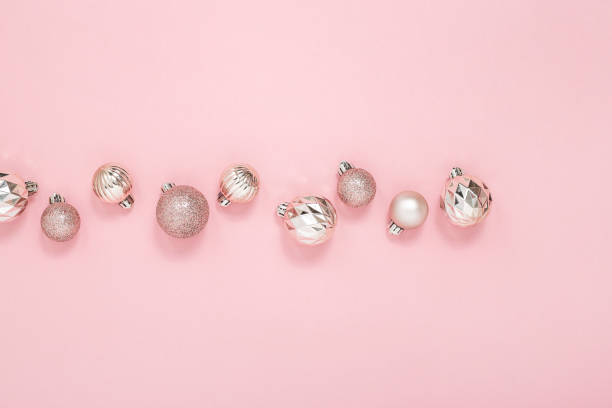 istock Decorative pink shiny balls on a pink background. Top view, flat lay. 1354421553