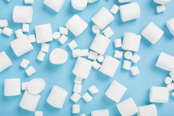 istock White marshmallows on a blue background. Top view, flat lay. 1354422229