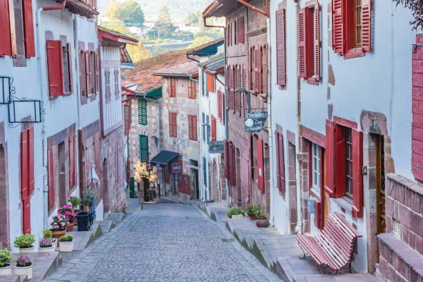 Cobblestoned street in the historic center of mountain village Saint-Jean-Pied-de-Port Cobblestoned street in the historic center of mountain village Saint-Jean-Pied-de-Port, France saint jean pied de port stock pictures, royalty-free photos & images