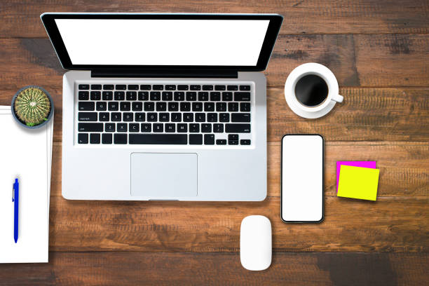 istock Top view over the tablet computer notebook with office style wooden floor. 1354424632