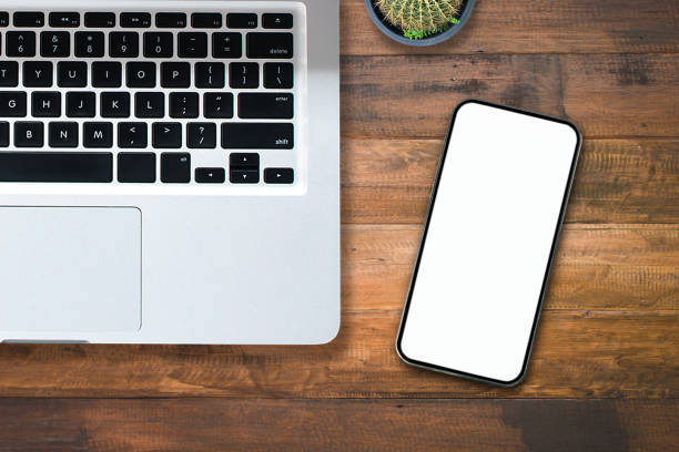 istock Top view over the tablet computer notebook with office style wooden floor. 1354424657