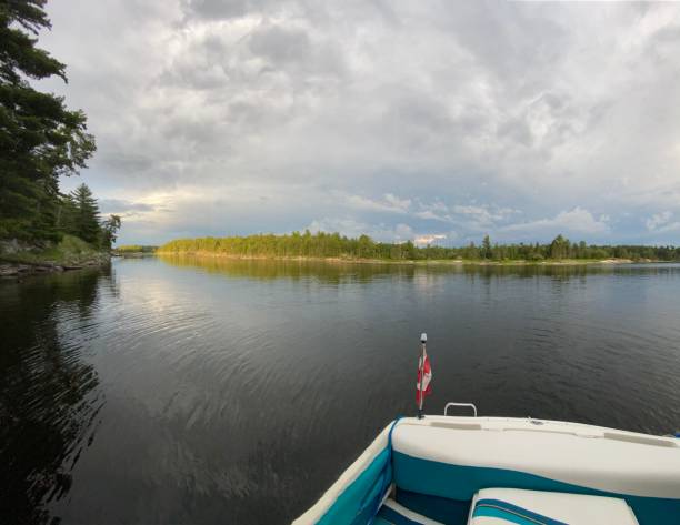 istock Rear view of boat and island 1354425187