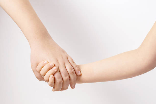 istock kids holding hands senior and junior friendship and support concept 1354425658
