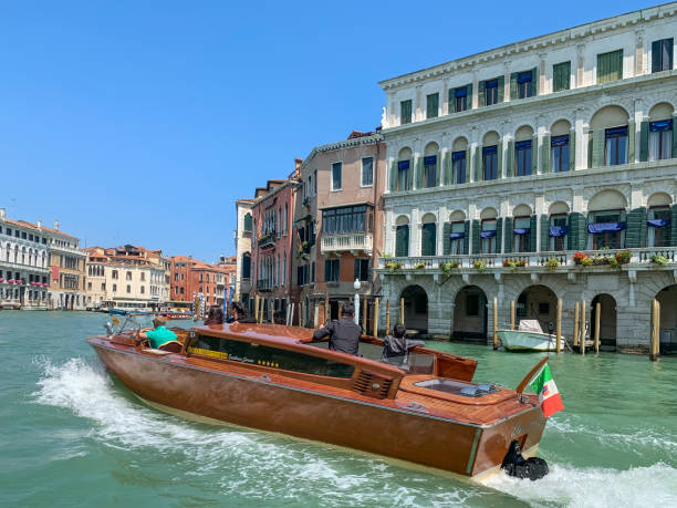 Transport in Venice Venice, Italy - May 23, 2019: water taxi is going on the canal watertaxi stock pictures, royalty-free photos & images