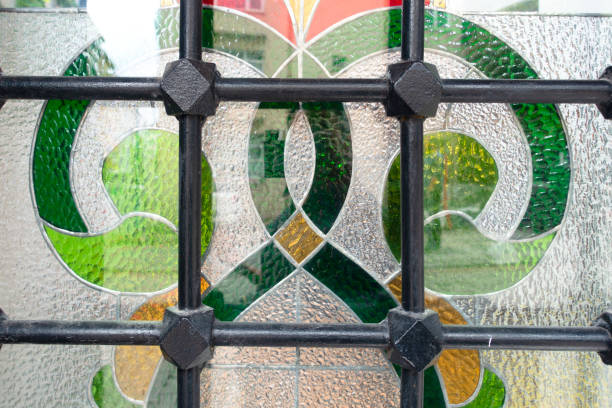 istock Window fence on multicolored painted glass window. 1354432597