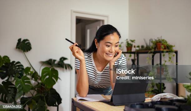 Cheerful Woman Gardener Making Video Call On A Digital Tablet In Her Flower Shop Stock Photo - Download Image Now