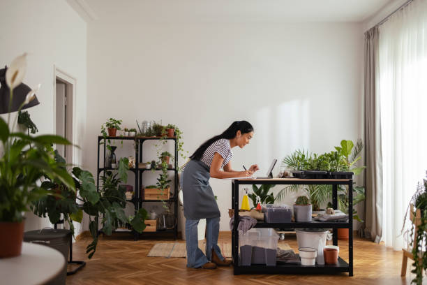 istock Serious Woman Florist Using Digital Tablet while Working at her Flower Shop 1354434380