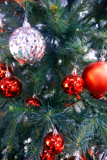 istock Christmas Tree With Baubles And Blurred Shiny Lights 1354437091