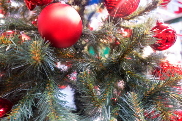 istock Christmas Tree With Baubles And Blurred Shiny Lights 1354437777