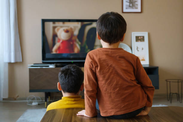 istock Children watching tv together at home 1354437816