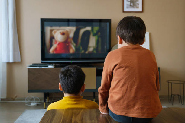 istock Children watching tv together at home 1354437825