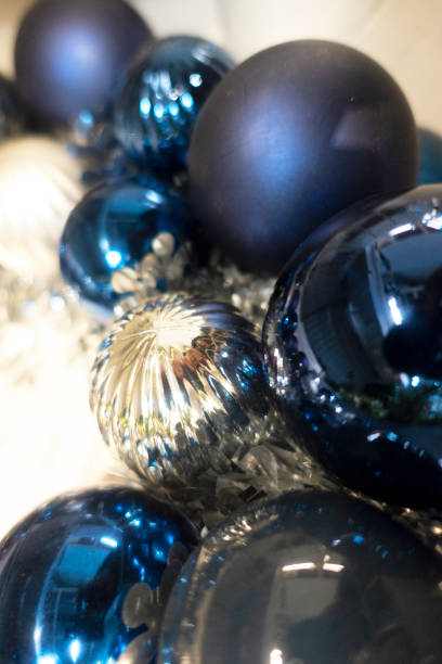 istock Blue colored Christmas Baubles And Blurred Shiny Lights 1354437831