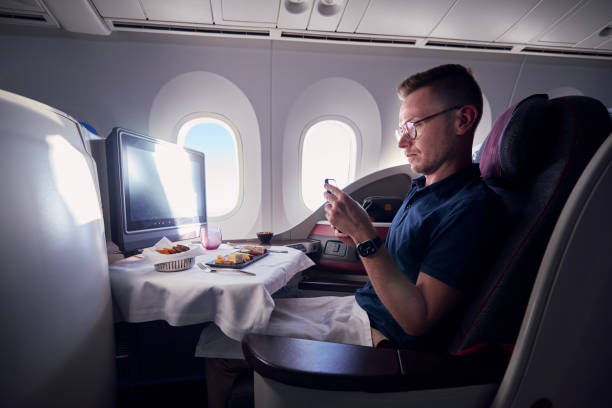비즈니스 클래스에서 비행 중 음식을 찍는 승객 - qatar airways 뉴스 사진 이미지