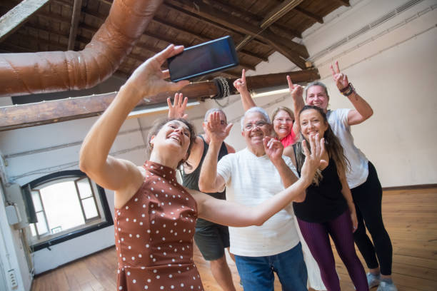 istock Cheerful senior dance group taking picture after class in studio 1354441948
