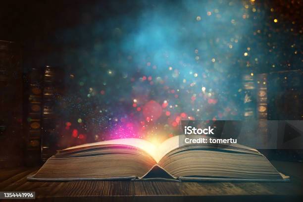 Image Of Open Antique Book On Wooden Table With Glitter Overlay Stock Photo - Download Image Now