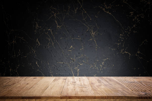 istock Empty table in front of gold and black marble textured background. For product display montage 1354443027