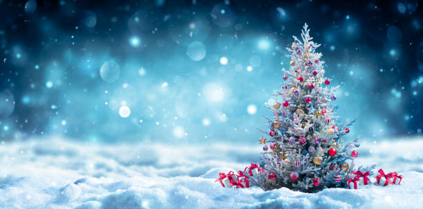 istock Christmas Tree With Gift Boxes On Snow At Night - Snowy Abstract Landscape 1354445137