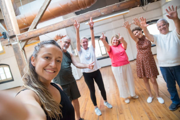 istock Happy young Caucasian dance teacher making selfie with seniors 1354446595